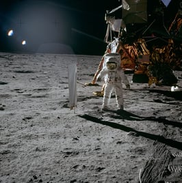 Buzz Aldrin looking at the Solar Wind Experiment, with Apollo 11 in the background